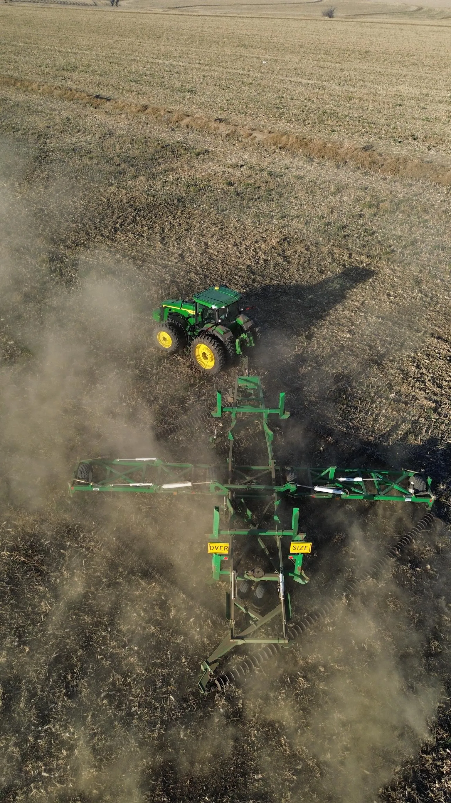 John Deere tractor and tillage implement working a field